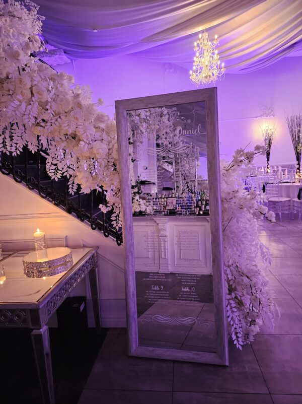 A Parisian mirror with custom white vinyl names and designs to serve as your guest chart as seen here for Laura's engagement event in Ariana's South done by PMT Party Services Group