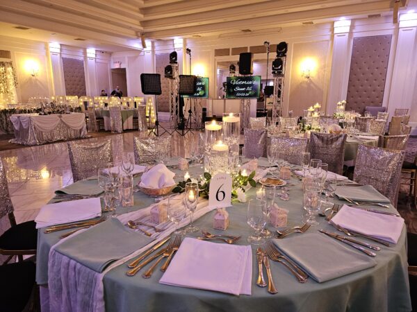 3 glass cylinders with floating candles, filled with clear water gel beads and decorated with acrylic diamonds, pearls, and floating candles, placed on a 12in mirror charger, surrounded by white/ivory rose garland and fairy lights, decorations, candle ceremony, Queen Tiffany throne, table setup, centerpieces, gold pedals for Victoria's Sweet 16 in Staten Island, New York at the Grand Plaza done by PMT Party Services Group