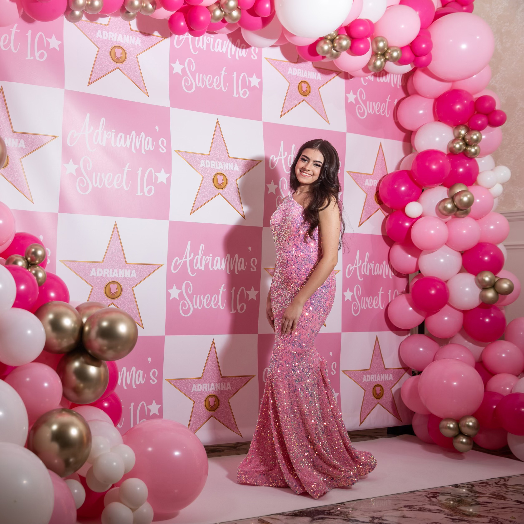 Adrianna's Sweet 16: Adrianna with her 10ftx8ft balloon garland and custom Hollywood themed backdrop at the Vanderbilt in Staten Island, New York done by PMT Party Services Group