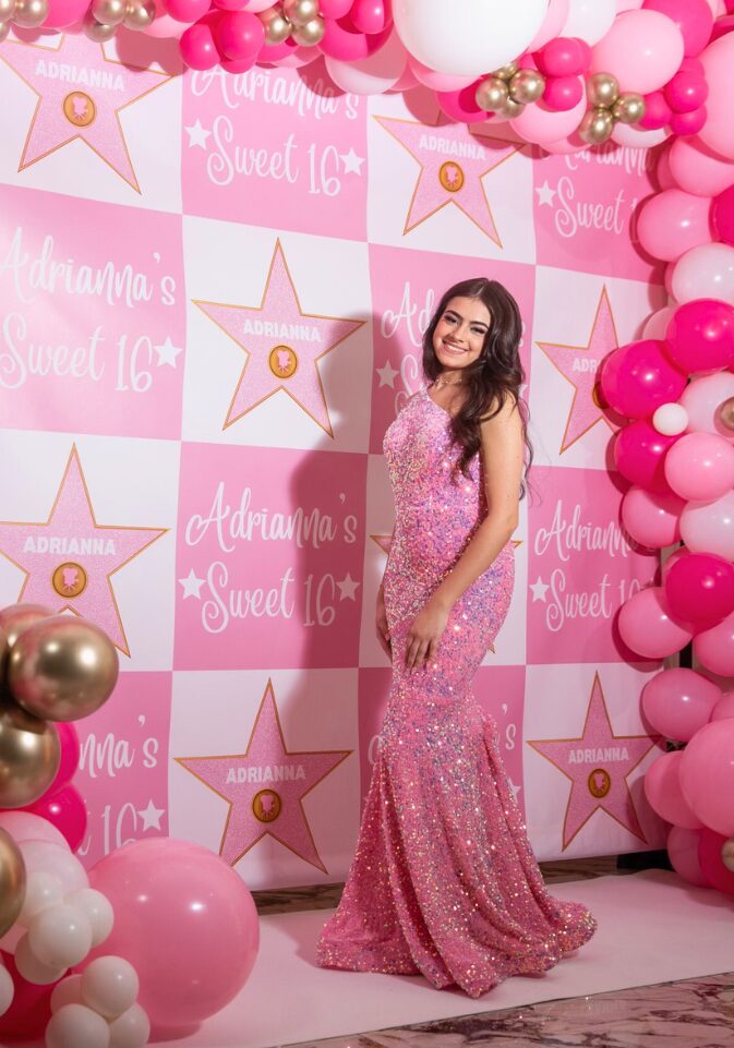 Adrianna's Sweet 16: Adrianna with her 10ftx8ft balloon garland and custom Hollywood themed backdrop at the Vanderbilt in Staten Island, New York done by PMT Party Services Group