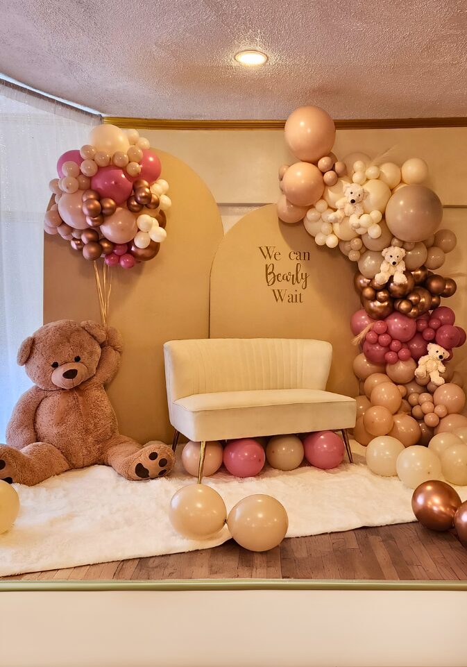 Jade's Baby Shower with a custom balloon garland, life sized teddy bear, couple's sofa, 2 half arches with light brown fabric, and a large white carpet done by PMT Party Services Group in Staten Island, New York