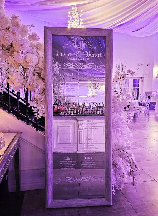 A Parisian mirror with custom white vinyl names and designs to serve as your guest chart as seen here for Laura's engagement event in Ariana's South done by PMT Party Services Group